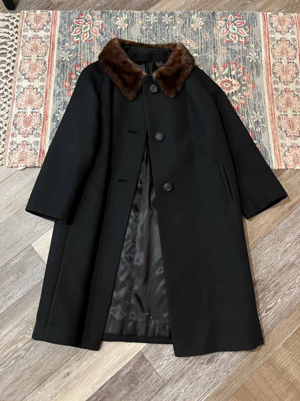 Vintage 1960s black wool coats featuring distinctive brown fur collars